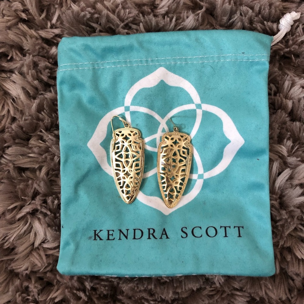 Kendra Scott gold caged earrings.